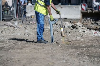 Technician exposing underground services during cable and pipe locating works