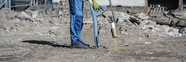 Technician exposing underground services during cable and pipe locating works