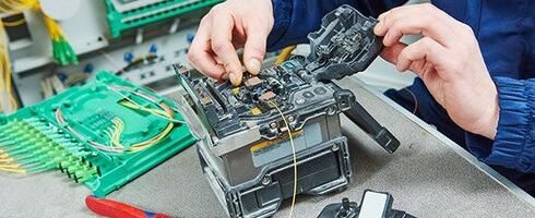 Fibre optic cable fusion splicing machine set up on a work table