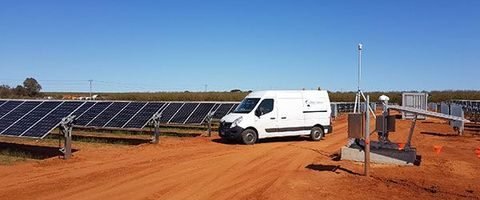 CableNet Industries service vehicle among rows of solar panels during pile driving works